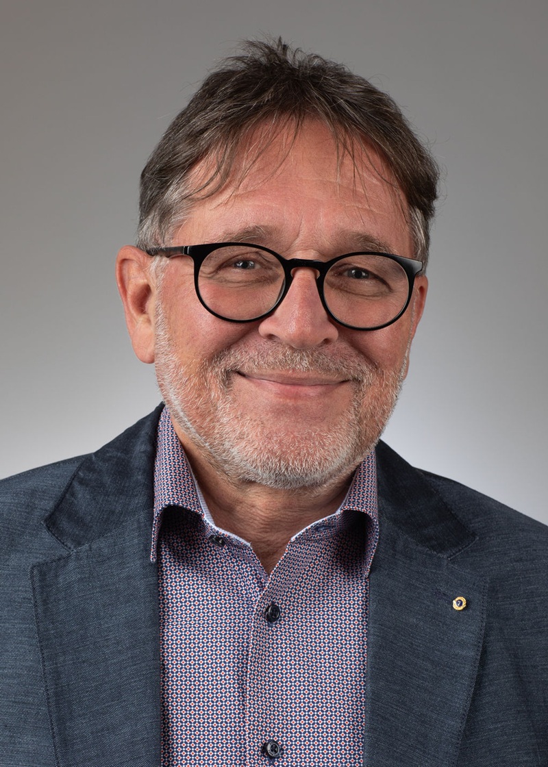man standing near white wall