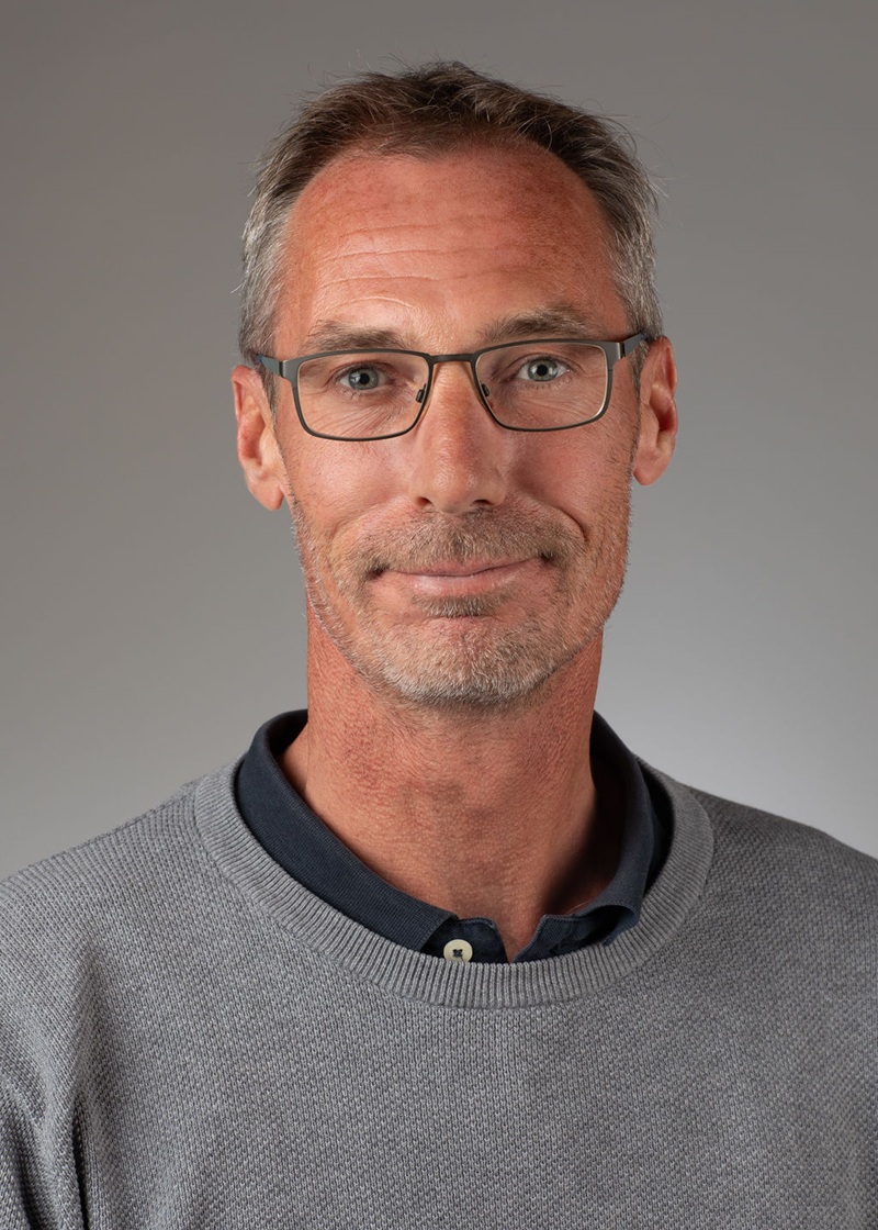 man standing near white wall
