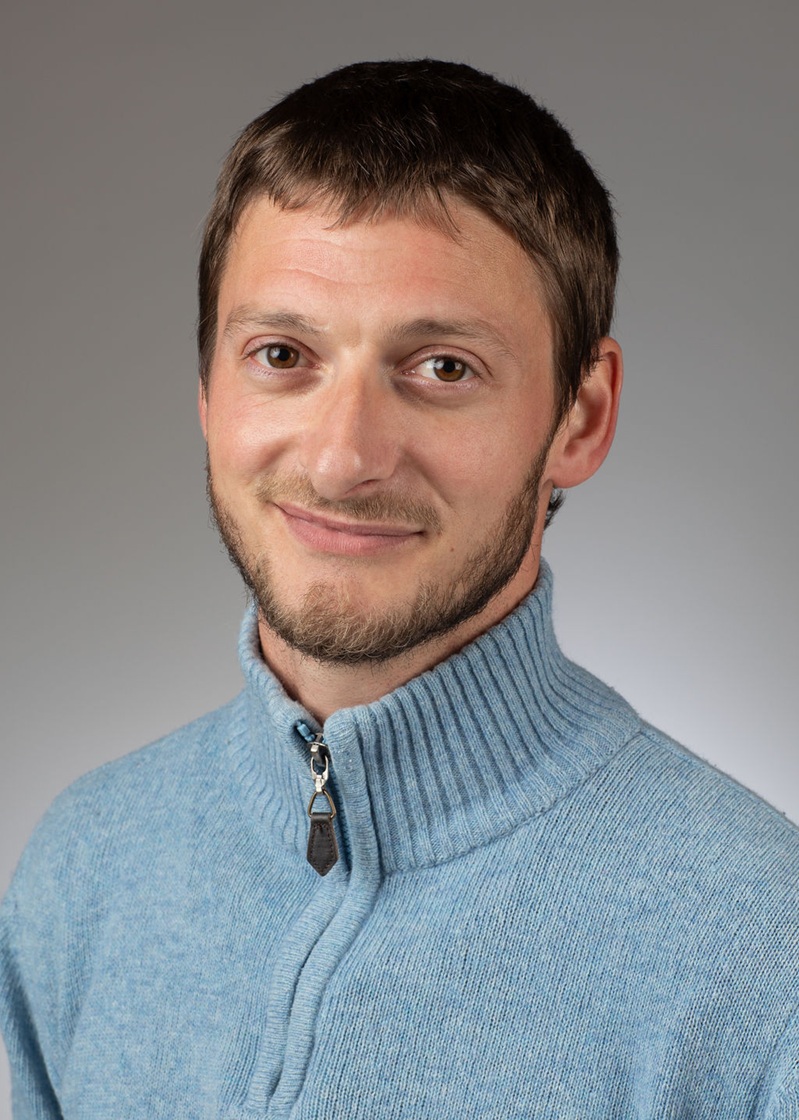 man standing near white wall
