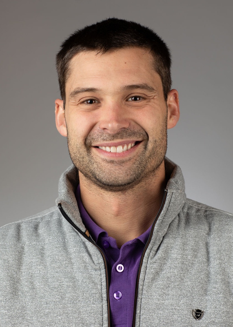 man standing near white wall