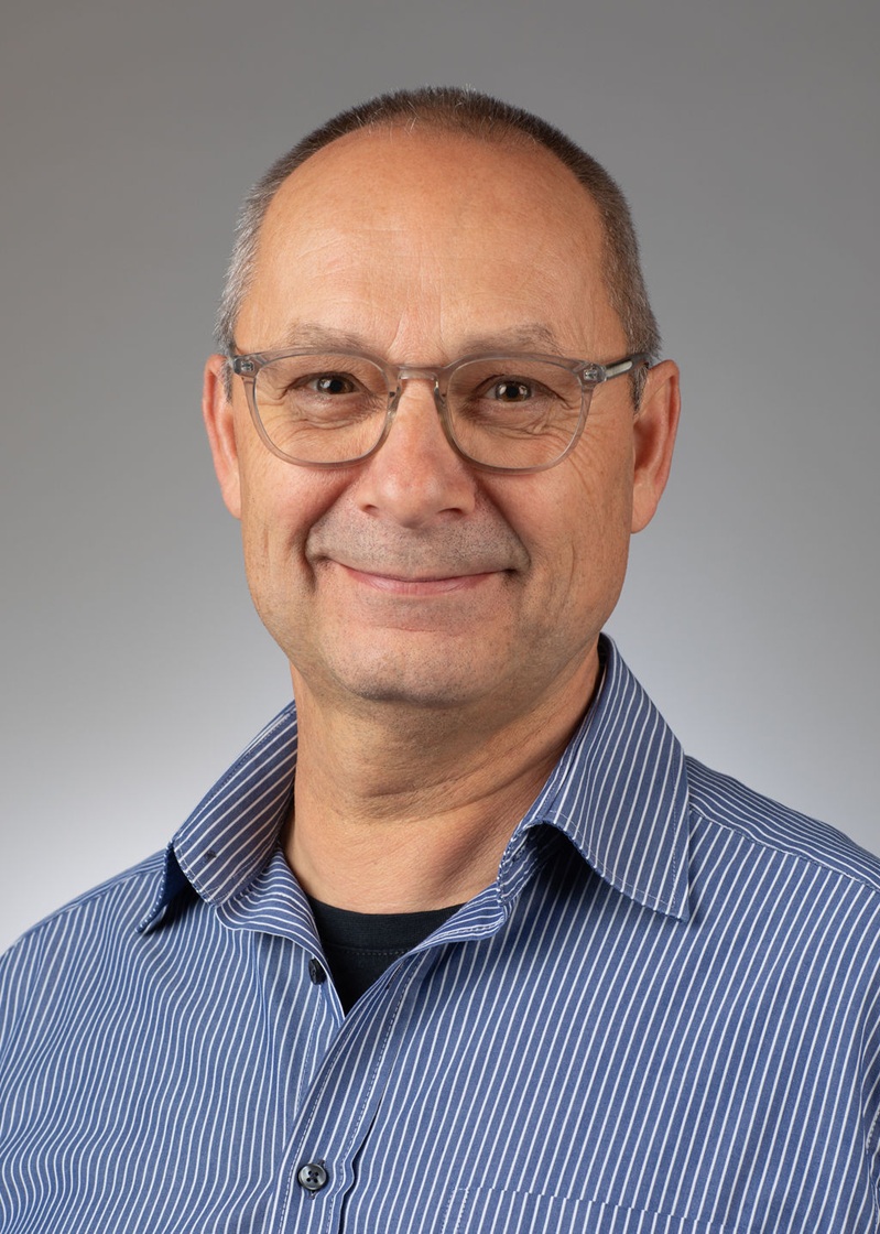 man standing near white wall