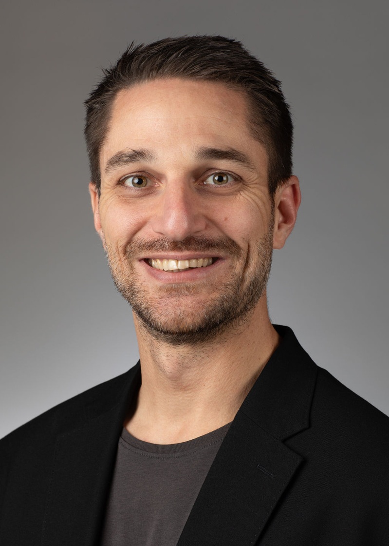 man standing near white wall