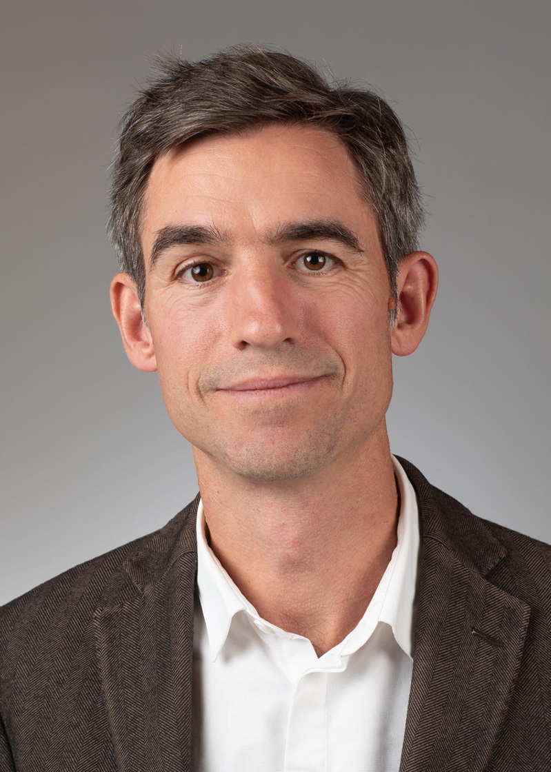 man standing near white wall