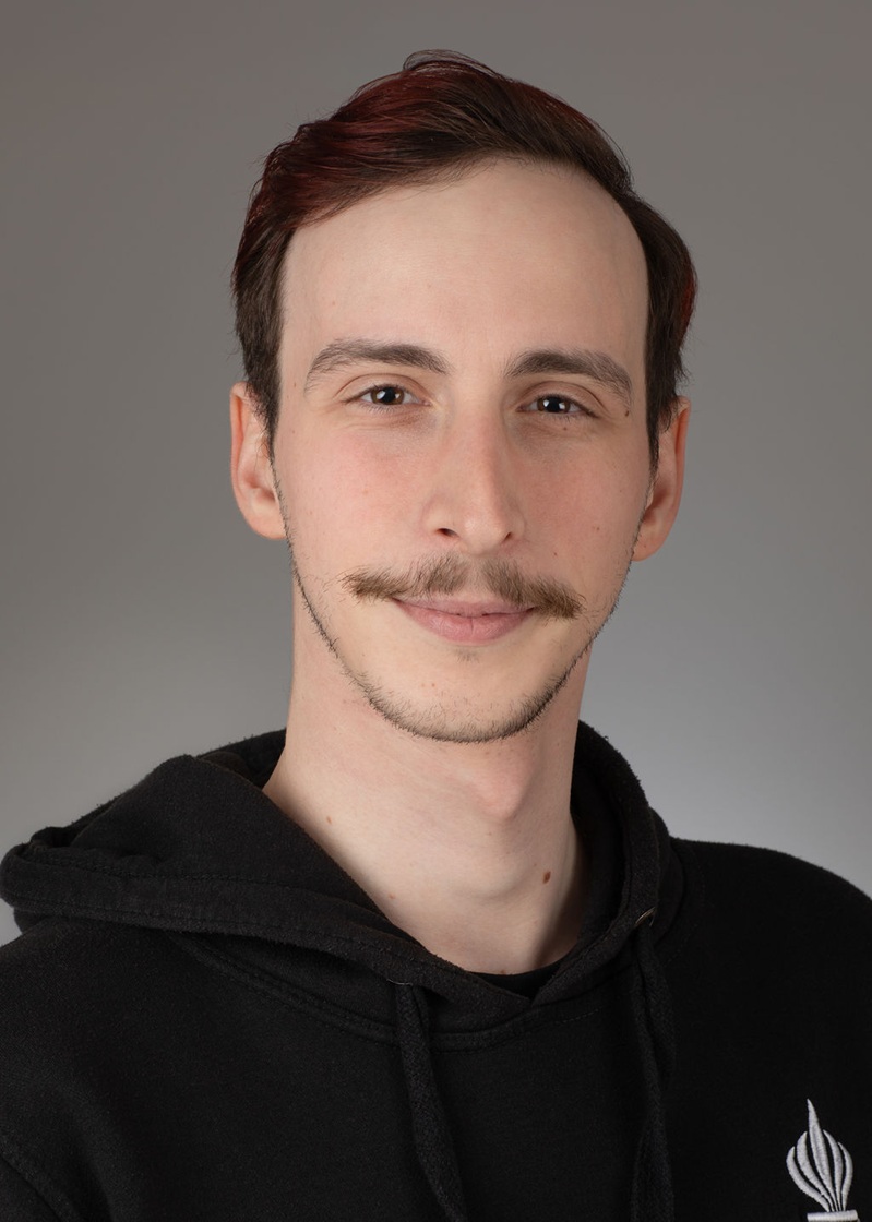 man standing near white wall