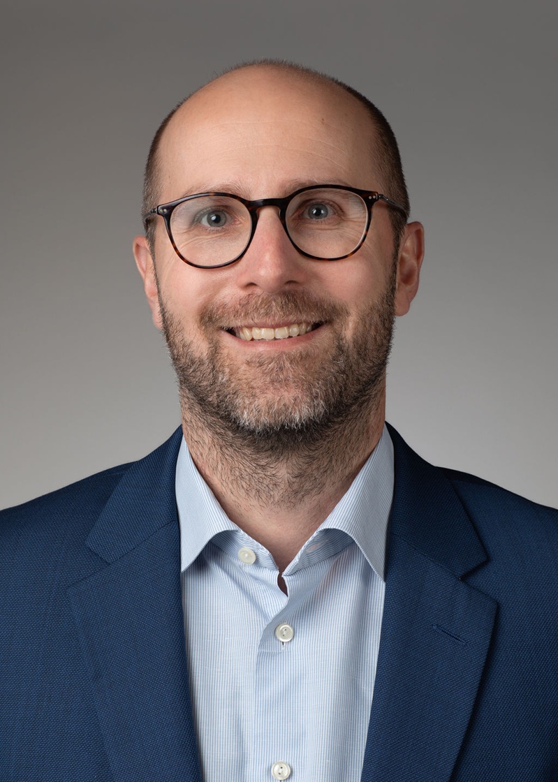 man standing near white wall