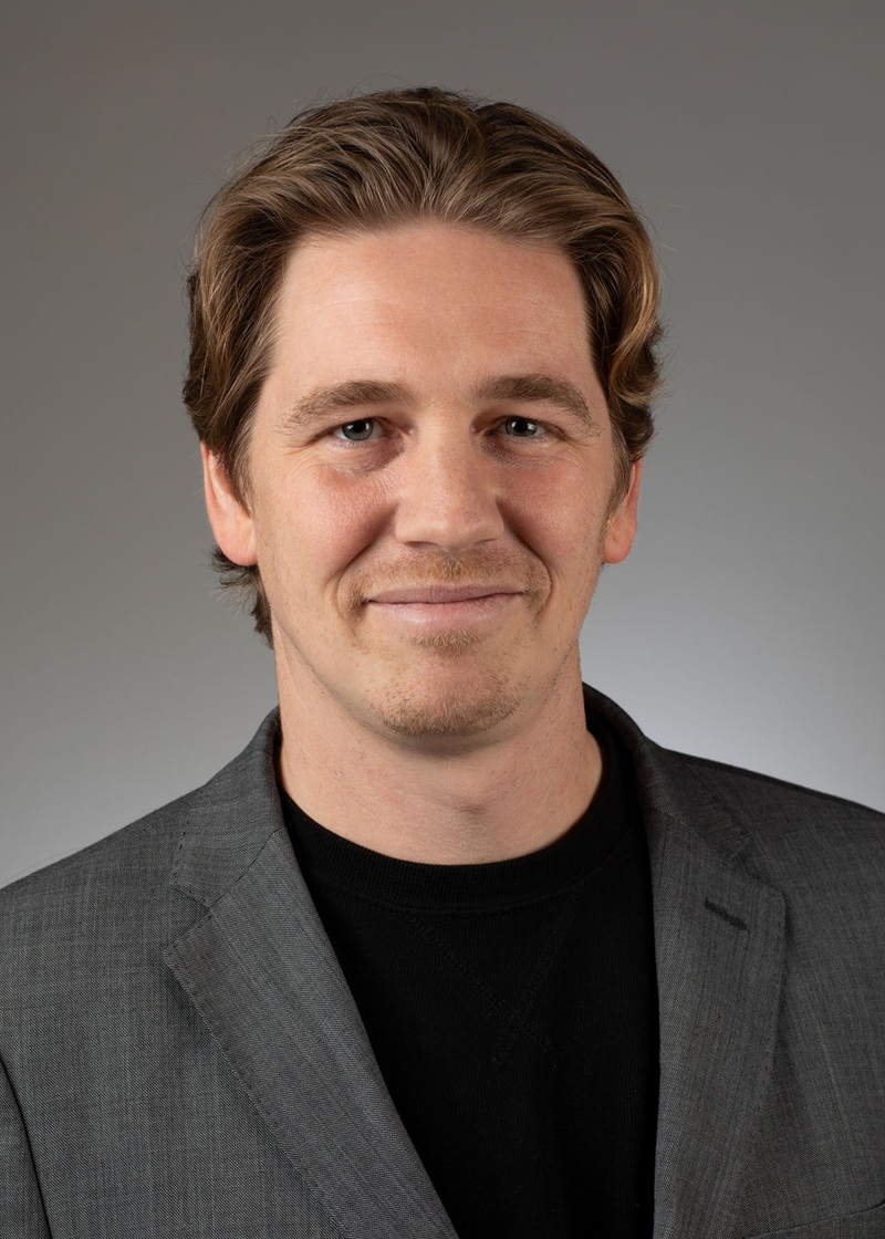 man standing near white wall